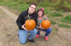 Christian and a woman holding pumpkins