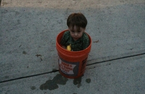 kid playing inside a bucket