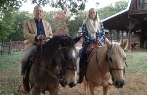 John H and a woman horseback riding